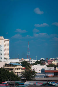 Buildings in city against blue sky