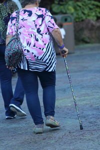 Rear view of people walking on footpath