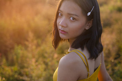 Portrait of young woman standing outdoors