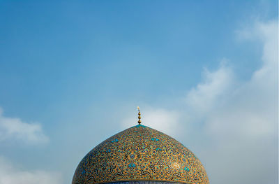 Low angle view of cross against sky