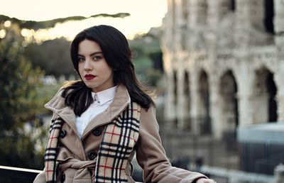 Portrait of young woman sitting outdoors