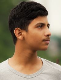 Close-up of young man looking away outdoors