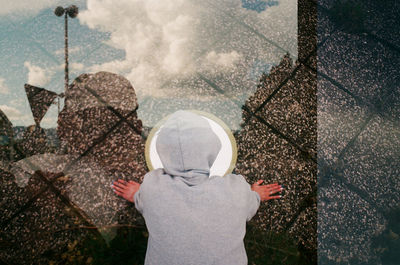 Rear view of person standing in rain