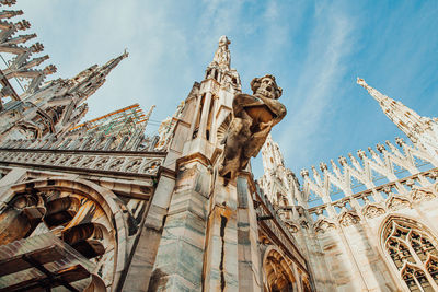 Low angle view of sculpture against building