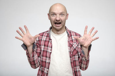 Portrait of man standing against white background