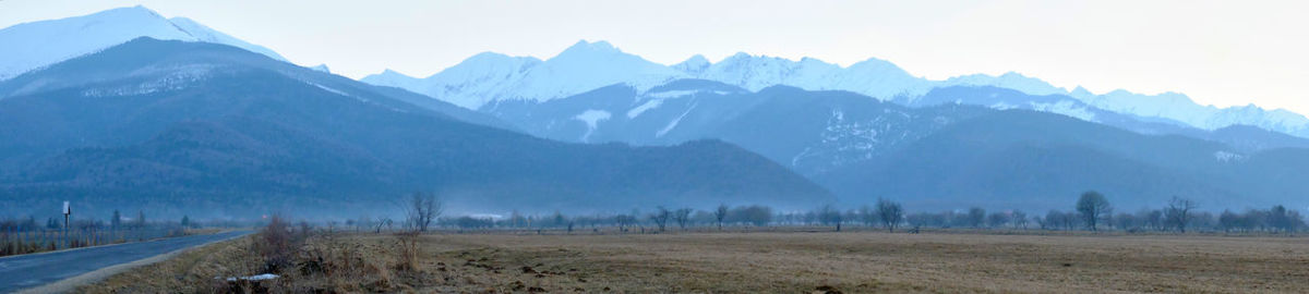 Scenic view of landscape and mountains against sky