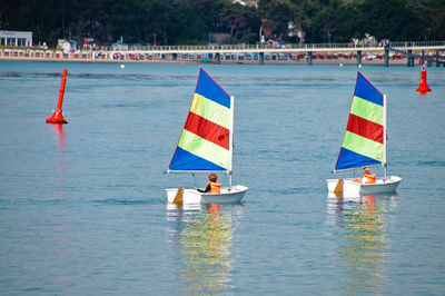 Children enjoying in sailboat at sea