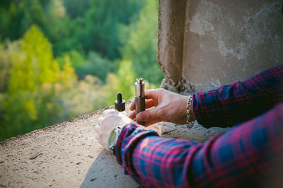 Close-up of man holding electronic cigarette