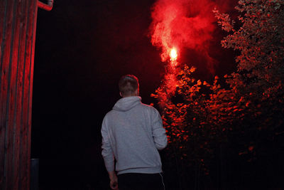 Rear view of man at night