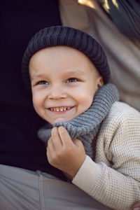 Boy child stands on the field with his parents in the fall