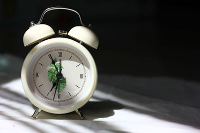 Close-up of clock on table
