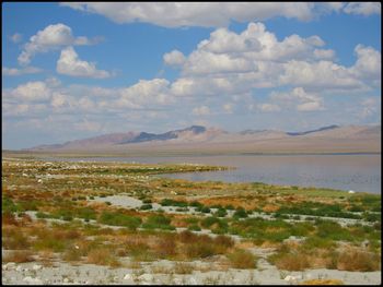 Scenic view of lake and mountains against sky