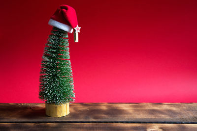 Close-up of christmas decoration on table against wall