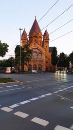 Road by building against sky in city