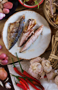 High angle view of fried mackerels in plate on table