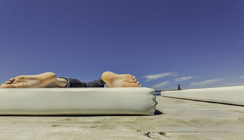 Low section of man lying on mattress