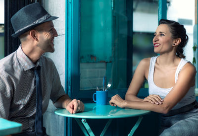 Couple sitting at table in cafe