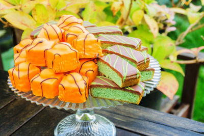 Close-up of dessert on cakestand at table