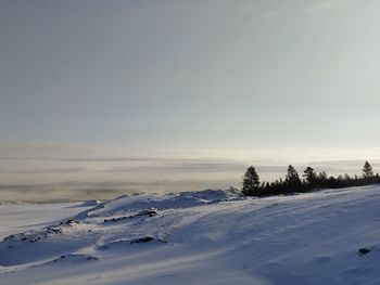 Scenic view of snow covered field against sky