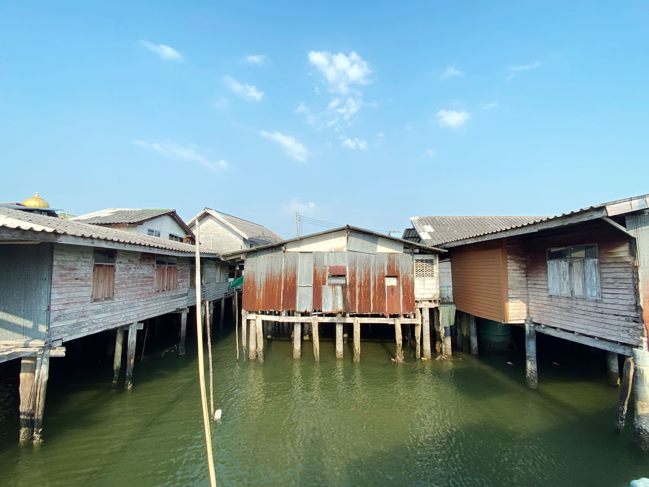 architecture, water, built structure, building exterior, building, house, stilt house, sky, nature, residential district, boathouse, day, no people, outdoors, vacation, nautical vessel, transportation, travel destinations, wood, cloud, blue, waterfront, canal, home, travel, estate