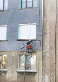 A man repair exterior wall 