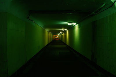 Empty corridor in illuminated tunnel