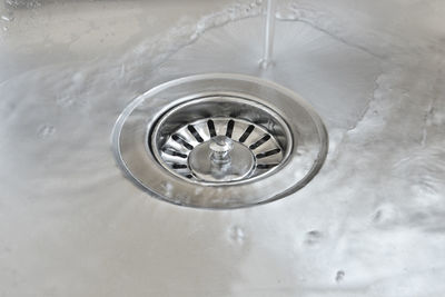 High angle view of faucet in water at home