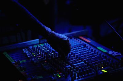 Close-up low angle view of human hand at night