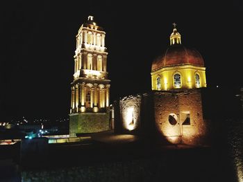 Low angle view of illuminated cathedral against sky at night