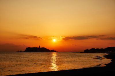 Scenic view of sea against romantic sky at sunset