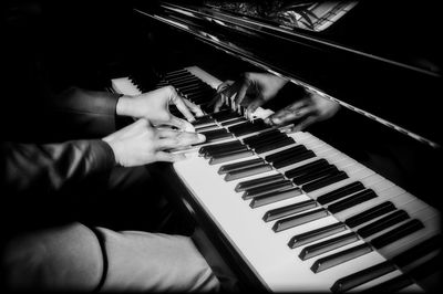 Close-up of man playing piano