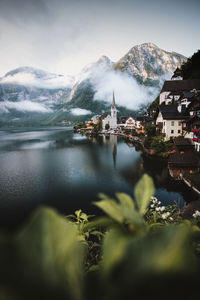 Scenic view of lake and buildings against sky