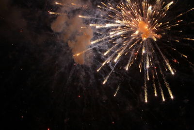 Low angle view of firework display at night