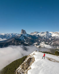 High angle view of man standing on snow covered mountain