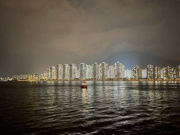 Illuminated city at waterfront