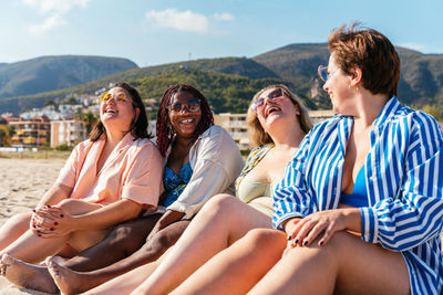 Friends sitting on beach