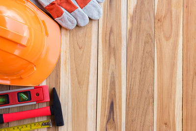 High angle view of multi colored pencils on hardwood floor
