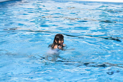 Portrait of woman swimming in pool