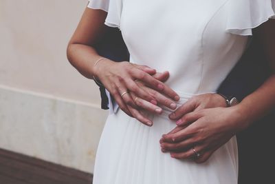 Midsection of couple embracing 