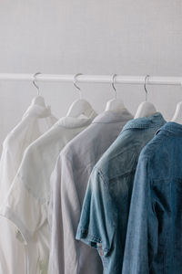 Close-up of clothes hanging on rack against wall