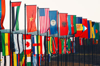 Multi colored flags hanging against clear sky