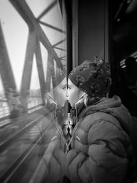 Close up of girl looking through train window