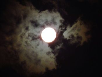 Low angle view of moon against dark sky