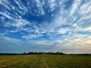 Scenic view of agricultural field against sky