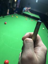 Midsection of person playing with ball on table