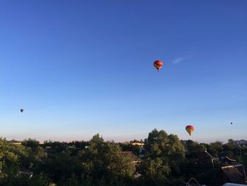 Hot air balloon flying against clear blue sky