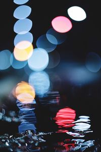 Close-up of illuminated lights on table in city at night