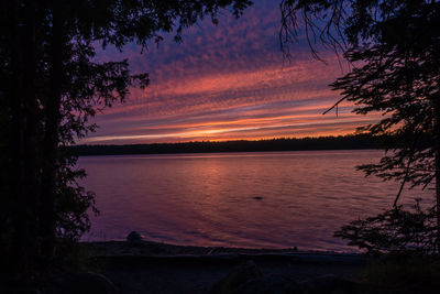 Scenic view of lake against romantic sky at sunset