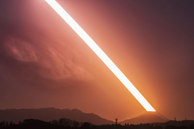 Scenic view of silhouette mountains against sky during sunset