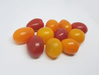 Close-up of multi colored candies against white background